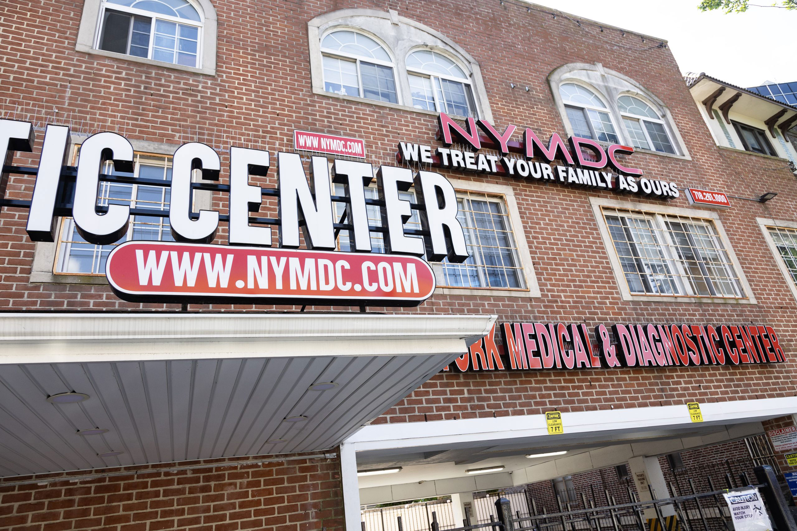 The image shows a sign for 'NYC Ticket Center' with the additional text 'We Treat Your Family's Dental Needs.